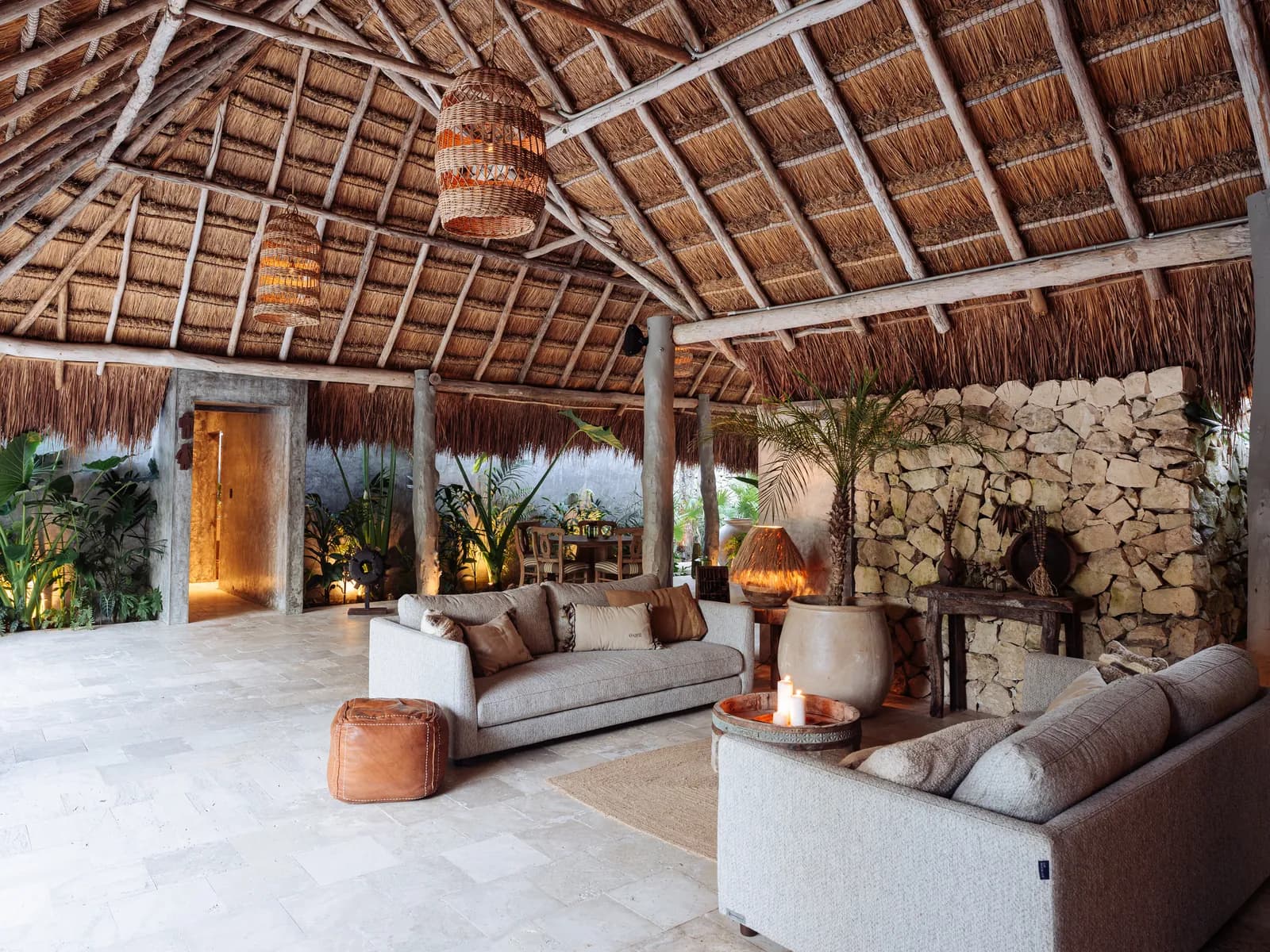 Onze Xpuha, palapa lounge with thatched roof and stone fireplace